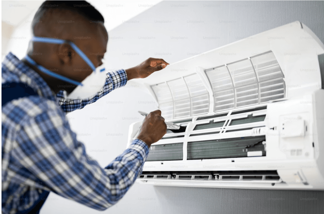 Technician fixing AC unit